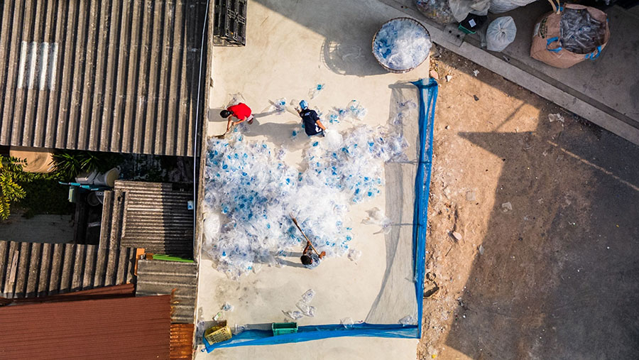 Relawan menyebarkan kantong plastik untuk dikeringkan di pusat daur ulang di Rayong, Thailand. (Andre Malerba/Bloomberg)