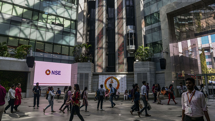 Pekerja berjalan di atrium gedung Bursa Efek Nasional India (NSE) di Mumbai, India. (Atul Loke/Bloomberg)