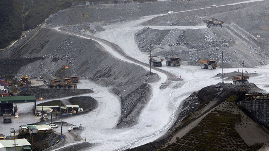 Truk angkut mengangkut bijih dari tambang terbuka di kompleks tambang tembaga dan emas Grasberg milik Freeport di Papua. (Dadang Tri/Bloomberg)