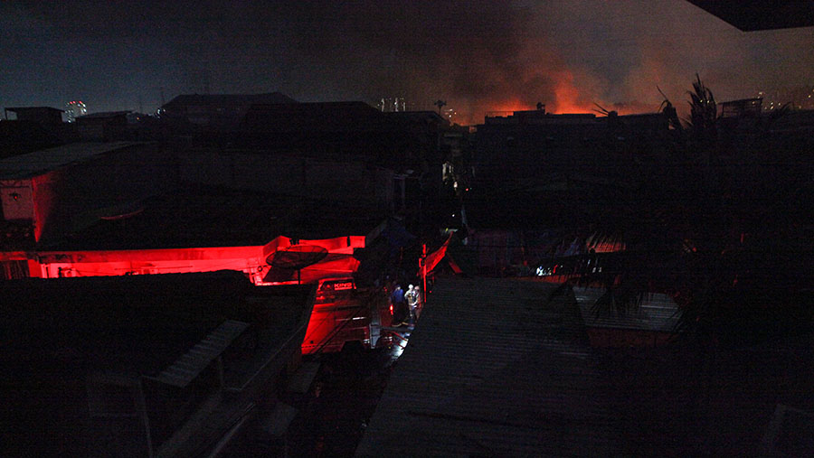 Api merembet hingga membakar sejumlah rumah warga di sekitar Terminal Bahan Bakar Minyak wilayah Plumpang,(Bloomberg Technoz/ Andrean Kristianto)