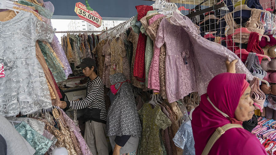 Pembeli memilih baju di toko pakaian di dalam pasar Tanah Abang di Jakarta Pusat,Rabu (30/3/2022). (Rony Zakaria/Bloomberg)