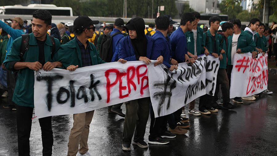 Hingga pukul 16.50 para mahasiswa masih menggelar aksi unjuk rasa dibawah guyuran hujan. (Bloomberg Technoz/ Andrean Kristianto)