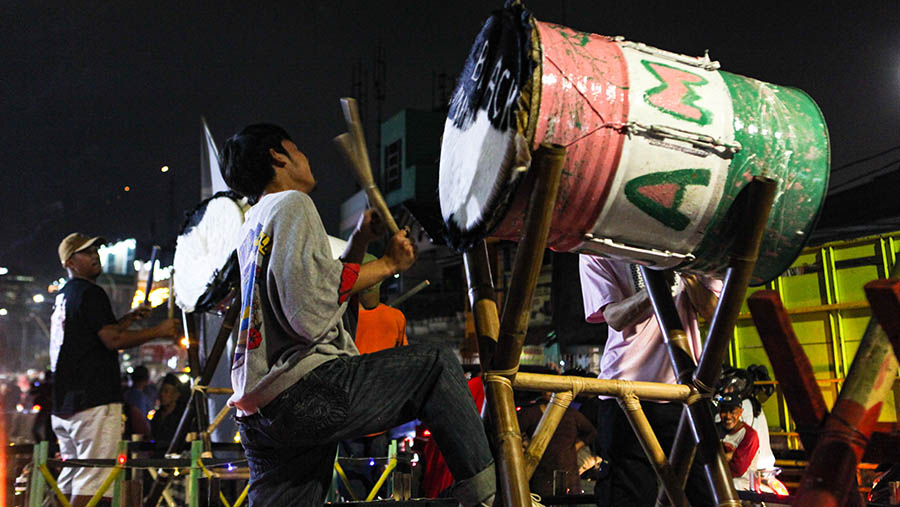 Warga menabuh bedug saat malam takbiran di kawasan Jalan Tambak, Manggarai, Jakarta, Jumat (21/4/2023). (Bloomberg Technoz/ Andrean Kristianto)