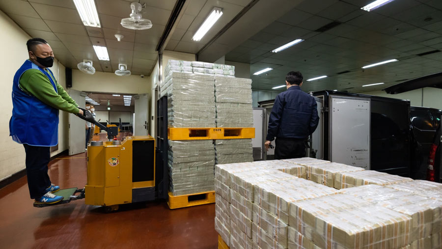 Seorang pekerja menggunakan forklift untuk memindahkan berkas uang kertas won Korea Selatan di Bank of Korea (SeongJoon Cho/Bloomberg)