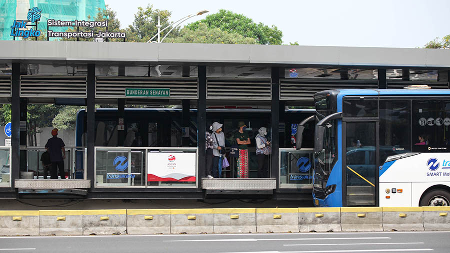 Penumpang menungggu bus Transjakarta di halte Transjakarta Bundaran Senayan, Jakarta, Selasa (30/5/2023) (Bloomberg Technoz/Andrean Kristianto)