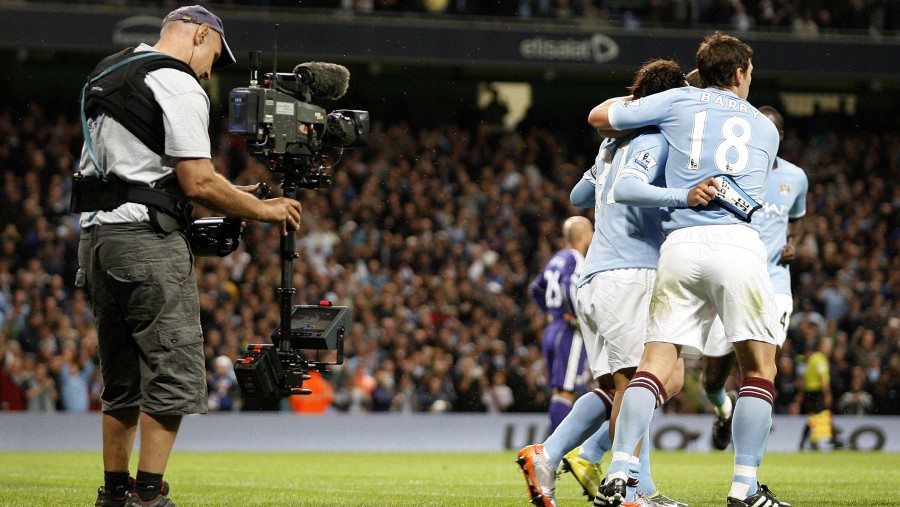A Sky Sports camera operator, left, films during Sky's television coverage of the soccer match between Manchester City and Liverpool (Bloomberg)