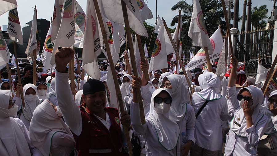 Selain itu mereka juga membawa poster dan bendera dalam aksi unjuk rasanya. (Bloomberg Technoz/ Andrean Kristianto)