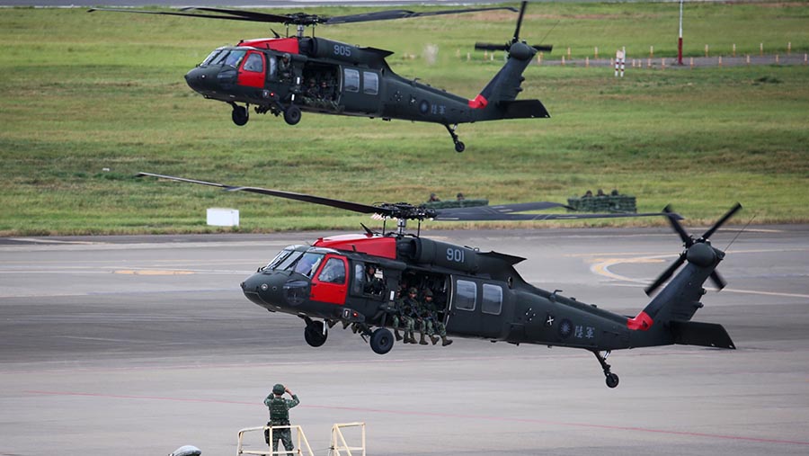 Helikopter UH-60 Black Hawk terbang selama latihan militer di Bandara Internasional Taoyuan, Taiwan, Rabu, (26/7/2023). ( I-Hwa Cheng/Bloomberg)