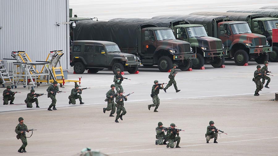 Saat pasukan musuh mendekati gedung bandara, terjadi baku tembak dengan militer Taiwan membela fasilitas tersebut, (I-Hwa Cheng/Bloomberg)