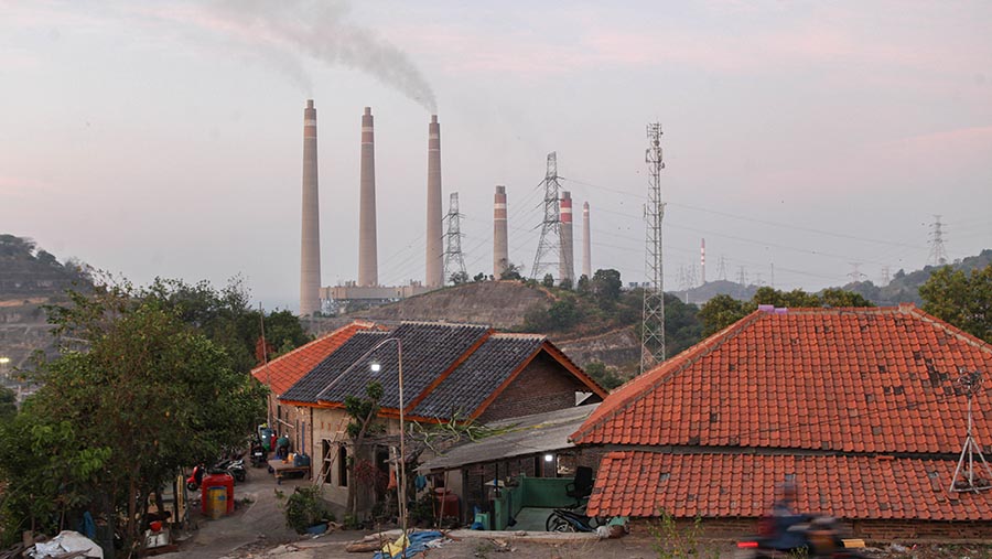 Pemukiman dengan latar PLTU Suralaya di Merak, Cilegon, Banten, Rabu (30/8/2023). (Bloomberg Technoz/Andrean Kristianto)