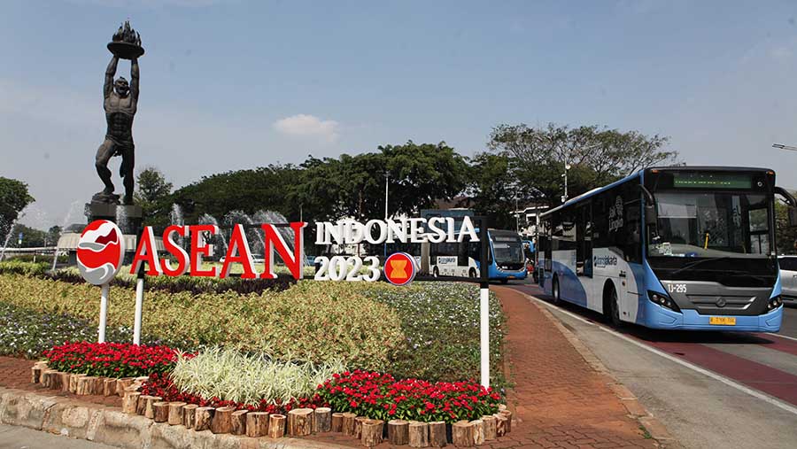 Transjakarta melintas di samping logo KTT ASEAN 2023 di Bundaran Senayan, Jakarta, Senin (4/9/2023).(Bloomberg Technoz/ Andrean Kristianto)