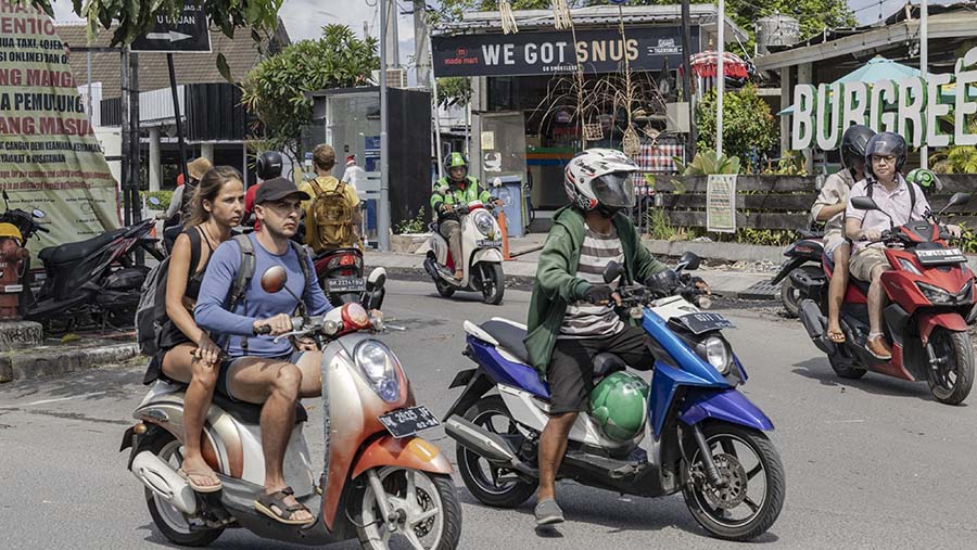 Pengendara sepeda motor di Canggu, Bali, Kamis (28/12/2023). (Nyimas Laula/Bloomberg)