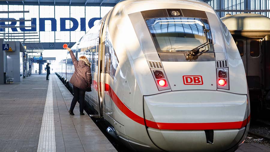 Kondektur memberi isyarat ke masinis kereta saat hari pertama pemogokan yang dilakukan di Munich, Jerman, Rabu (10/1/2024). (Michaela Rehle/Bloomberg)