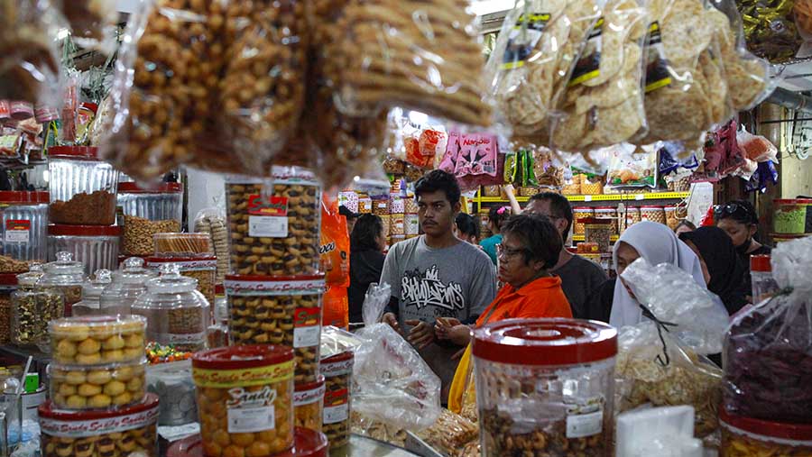 Pembeli berbelanja kue kering di Pasar Jatinegara, Jakarta, Kamis (28/3/2024). (Bloomberg Technoz/Andrean Kristianto)