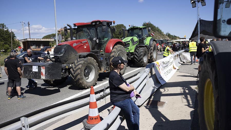 Para peserta aksi melakukan protes menggunakan traktor untuk memblokir jallan. (Angel Garcia/Bloomberg)