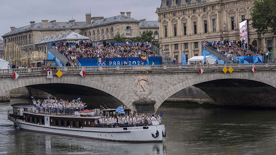 Tim Yunani di atas perahu saat upacara pembukaan Olimpiade Paris 2024 di Sungai Seine, Paris, Prancis, Jumat (26/7/2024). (Nathan Laine/Bloomberg)