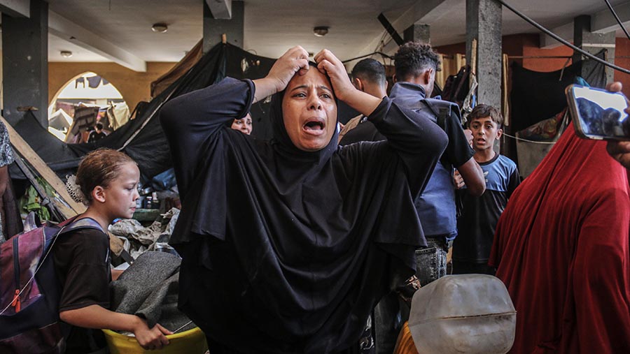 Seorang wanita menangis usai serangan udara Israel di sekolah Rufaida al-Aslamia di Deir Al-balah, Gaza, Kamis (10/10/2024). (Ahmad Salem/Bloomberg)