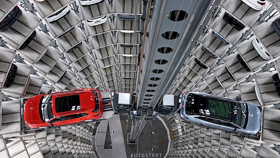 SUV VW Tiguan (kiri) dan mobil listrik VW ID.7 di dalam Autostadt Car Tower di Wolfsburg, Jerman, Jumat (15/11/2024). (Liesa Johannssen/Bloomberg)