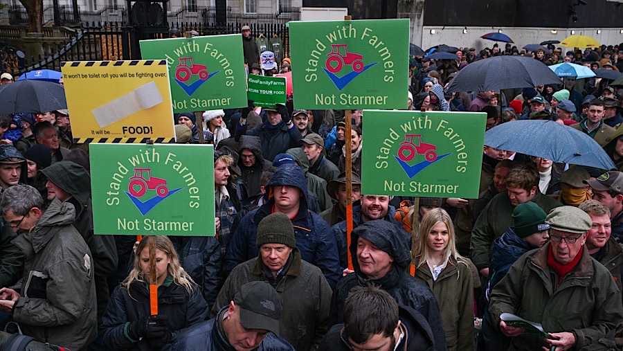 Petani memegang poster ‘Dukung Petani, Bukan Starmer’ saat demo perubahan pajak warisan, di London, Inggris, Selasa (19/11/2024). (Chris J. Ratcliffe/