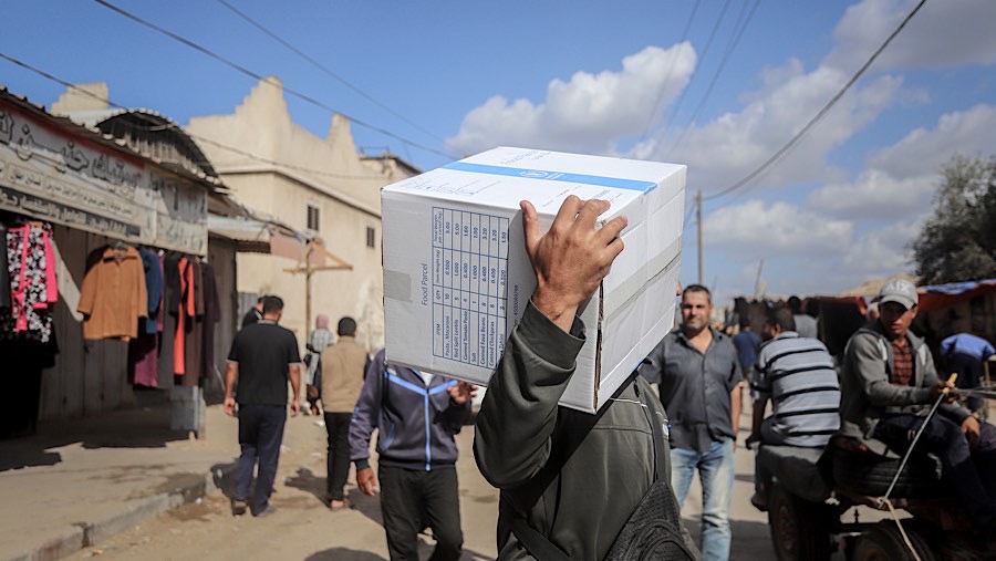 Warga membawa kotak bantuan pangan dari Program Pangan Dunia (WFP) di Deir al-Balah, Gaza tengah, Rabu (20/11/2024). (Ahmad Salem/Bloomberg)