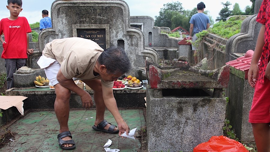 Di makam leluhur mereka melakukan sembahyang mendoakan leluhur yang telah tiada. (Bloomberg Technoz/Andrean Kristianto)