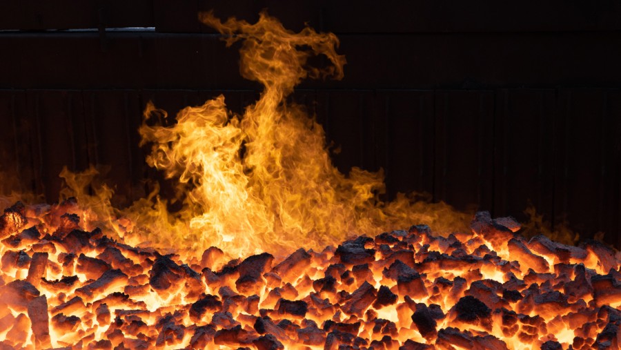 Flames rise from a heap of red hot coke coal./Bloomberg-Andrey Rudakov