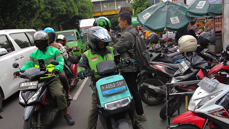 Pengemudi ojol membawa penumpang di kawasan Stasiun Palmerah, Jakarta, Selasa (20/5/2025). (Bloomberg Technoz/Andrean Kristianto)