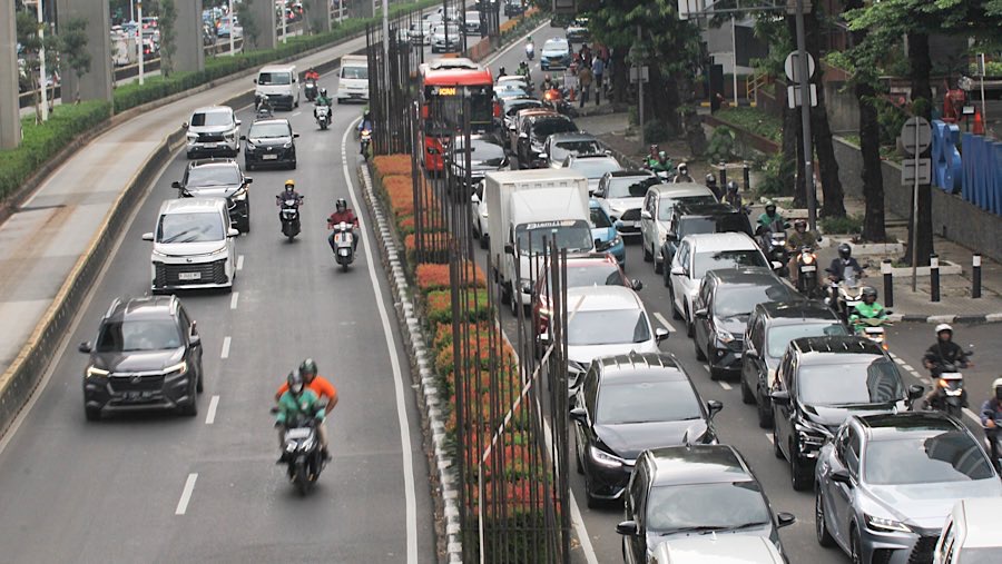 Pengendara melintas di dekat tiang proyek monorel Jakarta di kawasan Jalan HR Rasuna Said, Rabu (11/6/2025). (Bloomberg Technoz/Andrean Kristianto)
