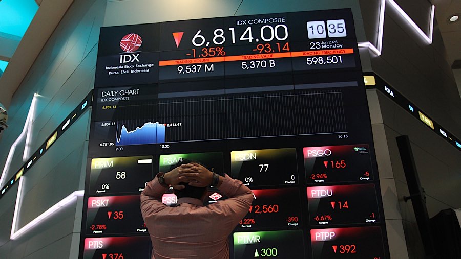Karyawan di depan layar indeks harga saham gabungan (IHSG) di Bursa Efek Indonesia (BEI), Senin (23/62025). (Bloomberg Technoz/Andrean Kristianto)
