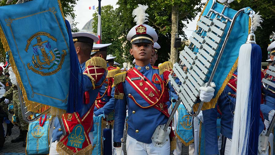Prajurit TNI mengawali parade dengan penampilan marching band yang memainkan lagu Maju Tak Gentar. (Nathan Laine/Bloomberg)