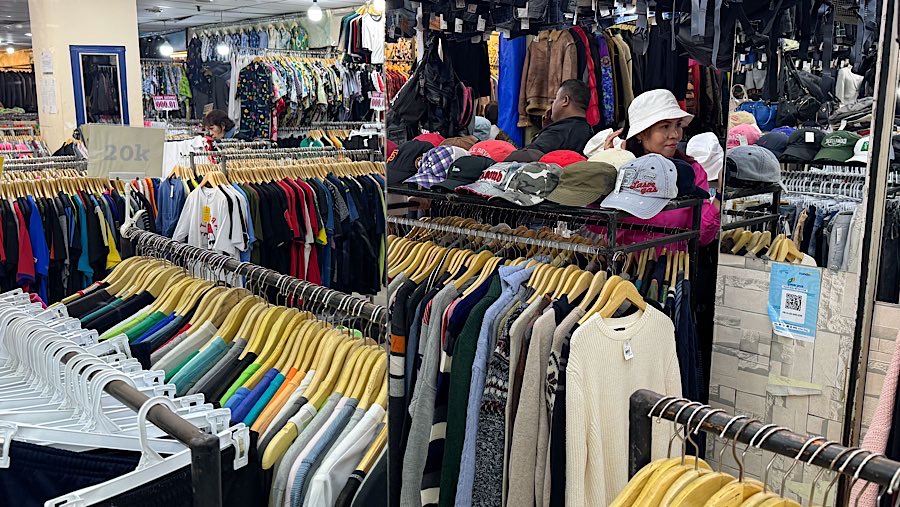 Calon pembeli melihat topi bekas (Thrifting) yang dijual di Pasar Baru, Jakarta, Kamis (31/7/2025). (Bloomberg Technoz/Andrean Kristianrto)
