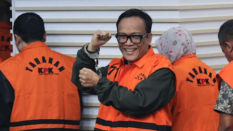 Saat akan keluar ruangan konfrensi pers Immanuel Ebenezer terlibat tersenyum sambil memperlihatkan borgol yang ia kenakan. (Bloomberg Technoz/Andre)