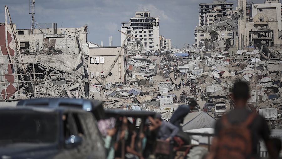 Warga Palestina berjalan ke utara di sepanjang Jalan al-Rashid menuju Kota Gaza, Gaza, Minggu (12/10/2025). (Ahmad Salem/Bloomberg)