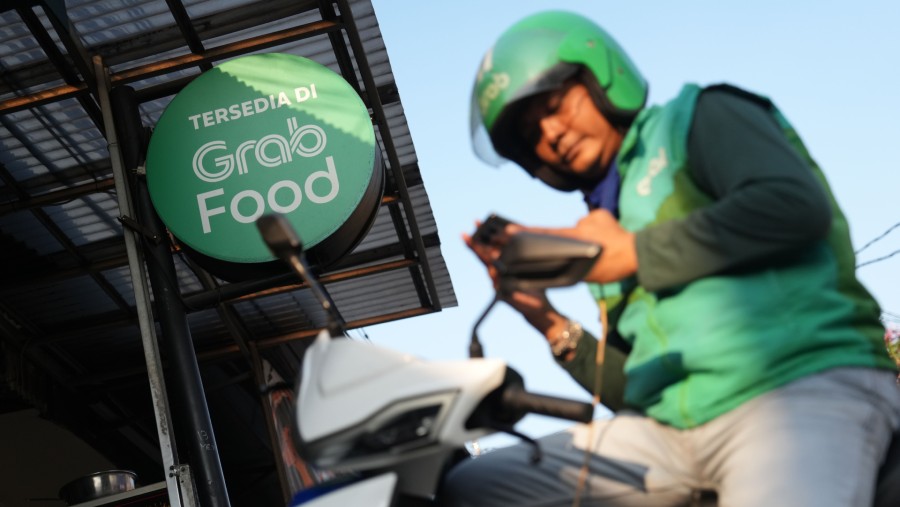Ilustrasi Grab. (Bloomberg)