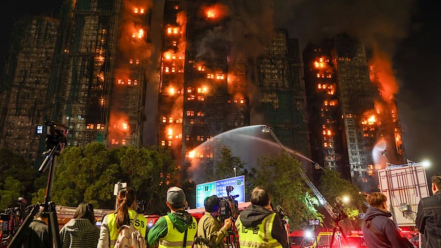 Petugas memadamkan api yang melanda gedung-gedung hunian di Wang Fuk Court, distrik Tai Po, Hong Kong, Rabu (26/11/2025). (Yik Yeung-man/Bloomberg)
