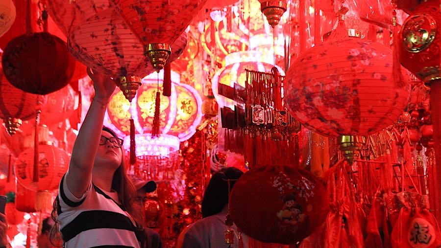 Calon pembeli memilih pernak pernik imlek yang dijual di kawasan Pecinan Glodok, Jakarta, Senin (2/2/2026). (Bloomberg Technoz/Andrean Kristianto)
