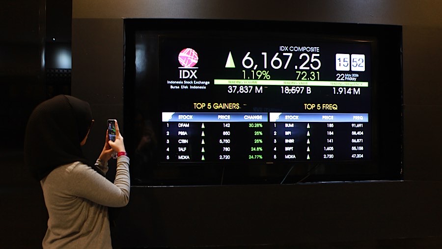 Karyawan memfoto layar pergerakan harga saham (IHSG) di Bursa Efek Indonesia (BEI), Jumat (22/6/2026). (Bloomberg Technoz/Andrean Kristianto)