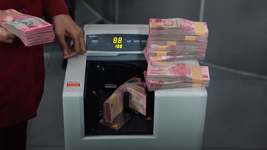 Karyawan menghitung uang rupiah di salah satu tempat penukaran mata uang di Jakarta, Kamis (4/6/2026). (Bloomberg Technoz/Andrean Kristianto)