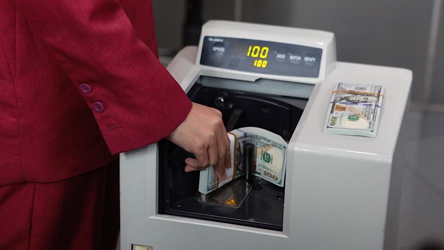 Karyawan menghitung uang dolar AS di salah satu tempat penukaran mata uang di Jakarta, Kamis (4/6/2026). (Bloomberg Technoz/Andrean Kristianto)