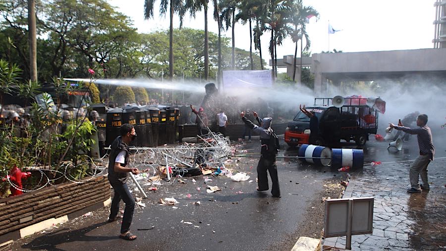 Kericuhan berangsur mereda setelah polisi menembakkan water cannon ke arah massa. (Bloomberg Technoz/Andrean)