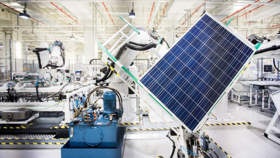 Sebuah robot menangani panel surya di jalur produksi modul di fasilitas manufaktur REC Solar ASA di Singapura./Bloomberg-Nicky Loh