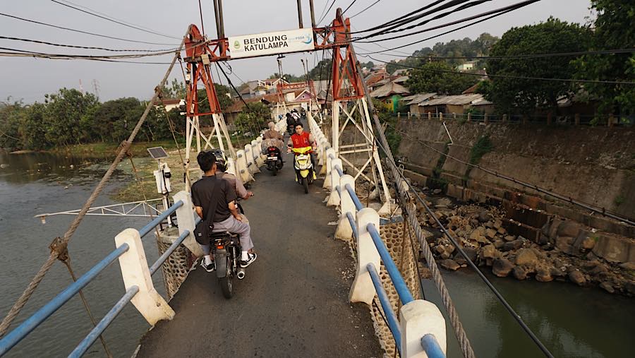 Pengendara motor melintas di jembatan Bendung Katulampa, Kota Bogor, Jawa Barat, Jumat (16/7/2026). (Bloomberg Technoz/Andrean Kristianto)