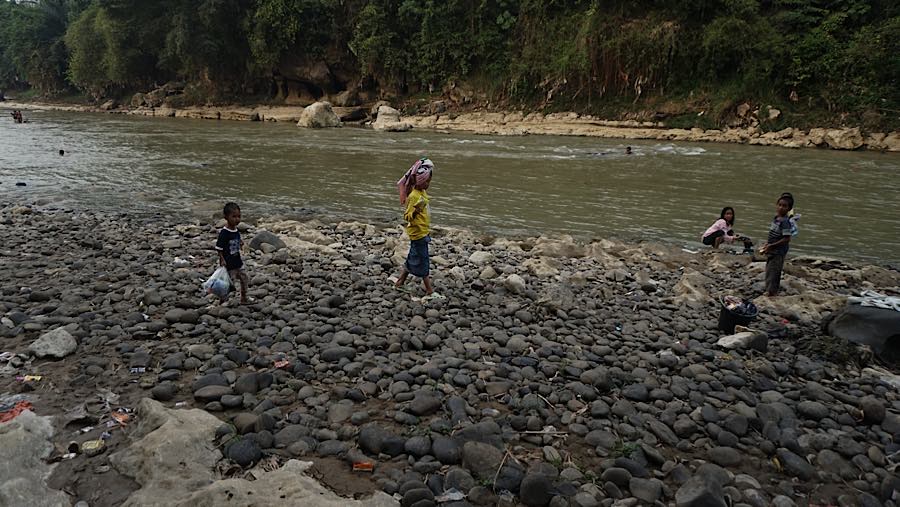 Selain untuk berenang, beberapa anak terlihat juga mencuci baju di area sungai Cisadane. (Bloomberg Technoz/Andrean Kristianto)