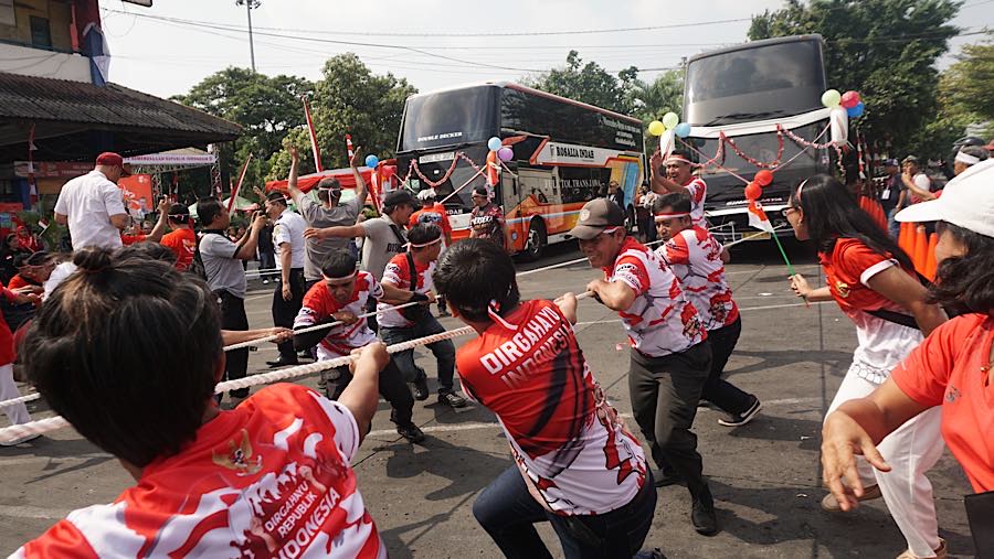 Sejumlah peserta mengikuti lomba tarik bus di Terminal Kampung Rambutan, Jakarta, Selasa (18/8/2026). (Bloomberg Technoz/Andrean Kritstianto)